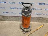 a fire extinguisor sitting on the ground next to a measuring tape