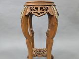 an image of a small wooden table with a carved top