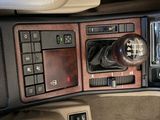 a picture of a car dashboard with a clock and a remote control