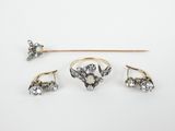 a set of three rings and a stick on a white surface