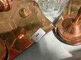 a glass of water sitting on a table next to a pair of scissors