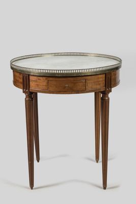 a round table with a glass top and wooden legs