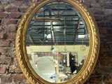 a mirror hanging on a brick wall near a brick wall