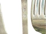 a fork and a spoon sitting next to each other