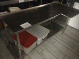 a kitchen with a table and a refrigerator in it