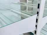 a glass shelf in the middle of a room