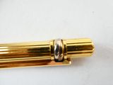 a close up of a gold colored object on a white surface