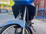 a blue motorcycle parked on the side of the road