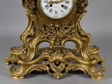 a gold clock that is sitting on a table