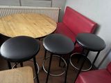 four stools and a table in the corner of a room