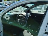 cars parked in a parking lot with their doors open and the driver ' s seat up