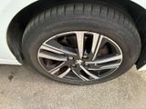 a close up of a tire on a white car