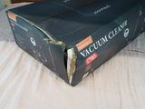a box of vacuum cream sitting on a bed