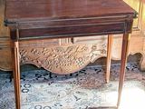 a small wooden table with a drawer on top of it