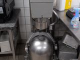 an image of a kitchen with a large metal ball on the floor