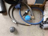 a bunch of hoses and a ball laying on the ground