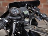 a close up of a motorcycle with a speedometer on it ' s handlebars