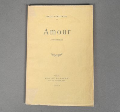 an old book with a yellow cover sitting on top of a table