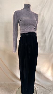 the mannequin is wearing a black skirt and a gray turtle neck sweater