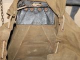 a brown bag with a metal chain hanging from it ' s side