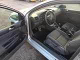 the interior of a car with the door open and the driver ' s seat down