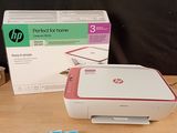 a printer sitting on top of a table next to a box of tissues