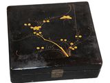 an old black box with a painting of flowers and birds on it