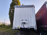 two trucks parked next to each other on the side of the road