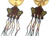 two pairs of earrings with a gold coin and tassels on them