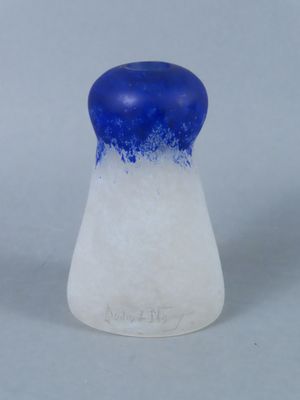 a blue and white salt shaker sitting on a table
