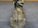a bronze statue of a dog with a hat and a cane