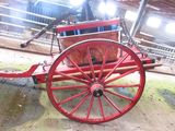a red wagon with a horse inside of it