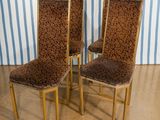 three chairs with leopard print upholstered on them in front of a striped wall