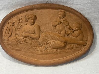 a plaque with a picture of a woman and two children