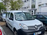 a white van parked in a parking lot next to other cars