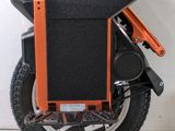 an orange and black scooter sitting on the floor