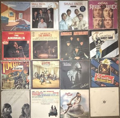 many different album covers on the wall of a room
