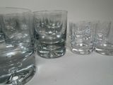 a lot of glasses sitting on a table next to each other