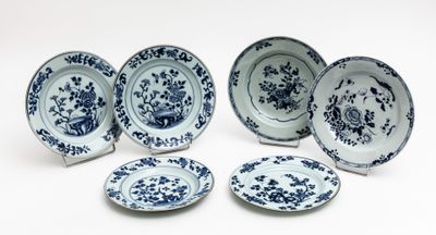 six blue and white plates with flowers and birds on them