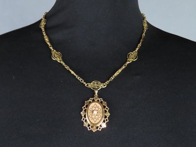 a woman wearing a black shirt and a gold necklace