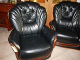 two black leather recliners that are sitting on a tile floor