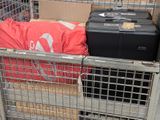 many suitcases in a metal cage in a store