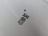a close up of a toilet with a sticker on it