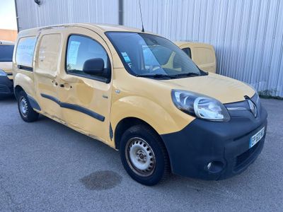 yellow and black van parked in a parking lot next to a building