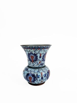 a blue and red vase sitting on a white surface