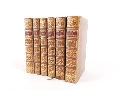 three books are stacked on top of each other on a white surface