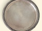 an image of a silver plate with a rope around the edge