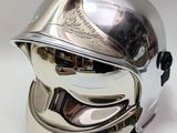 silver motorcycle helmet on a white background with a reflection of the helmet