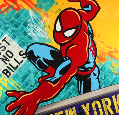 a poster of a spider - man hanging on the side of a building