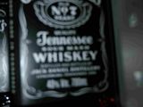 two bottles of jack daniels whiskey sitting on top of a counter
